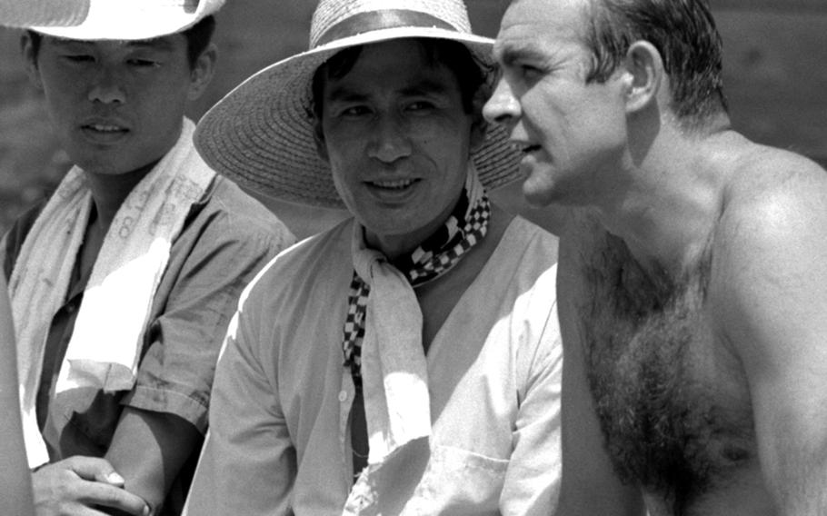 Sean Connery talks with Tetsuro Tanba, center, who plays the role of detective Tiger Tanaka, during the filming of ''You Only Live Twice.''