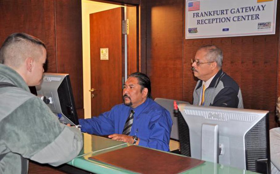David Laxa and Tony Bonilla, reception technicians with the Frankfurt Gateway Reception Center, assist Soldiers and families upon their arrival at the Frankfurt Airport in 2010.