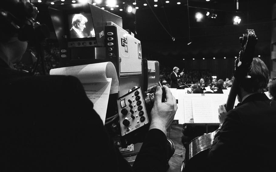 Leonard Bernstein conducts the New York Philharmonic during the orchestra's Bicentennial European tour. The concert at the Jahrhunderthalle, which was taped for German television, marked the halfway point in the tour.