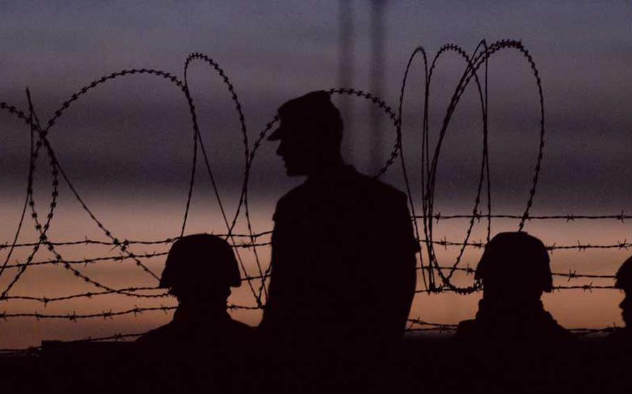 A group of soldiers are silhouetted against the evening sky, Saturday, Jan. 15, 2011, in Kandahar, Afghanistan. 
                