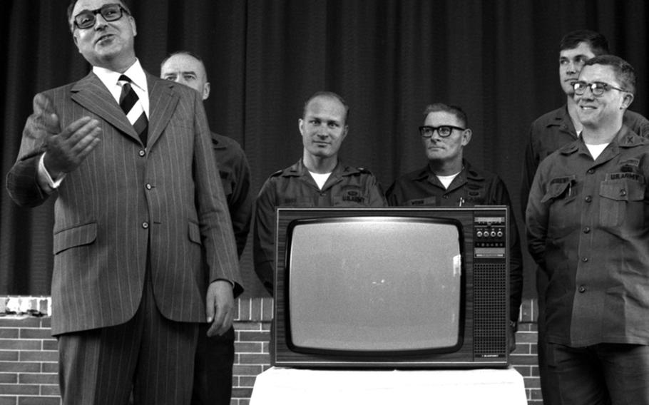 Dr. Helmut Kohl, minister-president of Rheinland-Pfalz, presents a color television to troops of the 1st Brigade, 8th Infantry Division, during a 1973 visit to Lee Barracks. It was the first of five TVs to be presented to the 8th ID; the future German chancellor also gave a set to personnel at Ramstein Air Base.