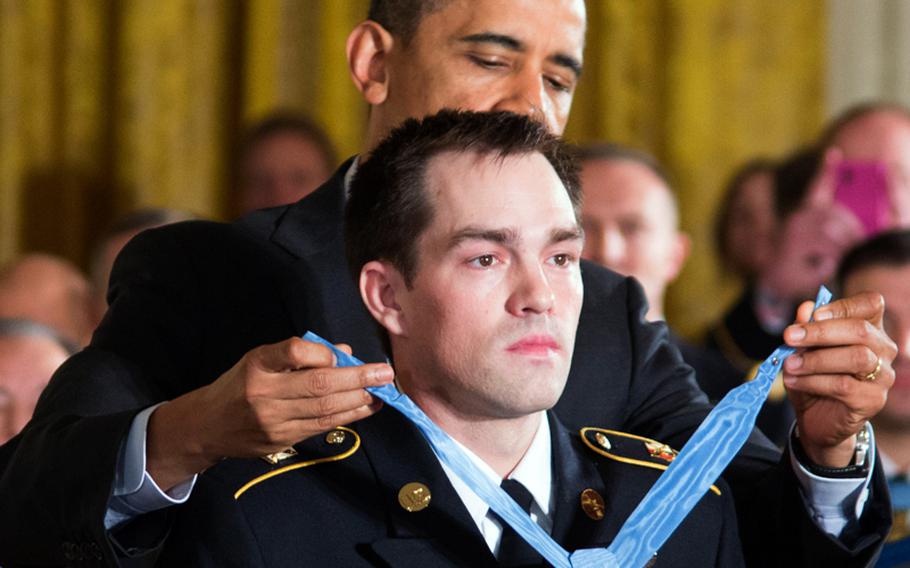 President Barack Obama presents the Medal of Honor to former Army Staff Sgt. Clinton Romesha Monday, Feb, 11, 2013, at the White House.