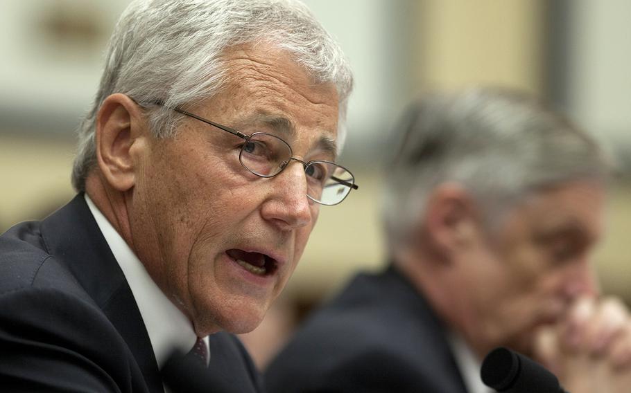 Defense Secretary Chuck Hagel, left, testifies on Capitol Hill in Washington, Thursday, April 11, 2013, before the House Armed Services Committee hearing on the Defense Department's fiscal 2014 National Defense Authorization Budget Request. At right is Defense Undersecretary, Comptroller Robert F. Hale.