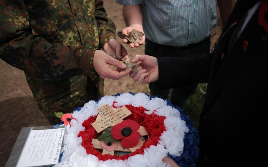 Germans in the town of Laumersheim, Germany, show fragments of the aluminum skin of the British Lancaster bomber ED 427, which went down April 17, 1943. It was long believed the ED 427 went missing over the North Sea, but crash debris and war records led researchers to conclude the plane went down in Laumersheim. On the 70th anniversary of the crash, Englishman Paul Keeley, a friend of one of the pilot's family, laid a wreath and small wooden crosses from some of the surviving families at the crash site.