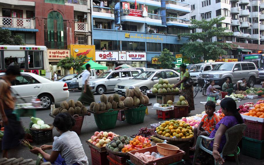 Street life is pictured on Maha Bandoola Road in Chinatown in Yangon, Myanmar, October 12, 2012. Yangon, home to four million of the country's 55 million people, doesn't feel like the massive urban centers that dot Asia such as neighboring Bangkok or Mumbai.