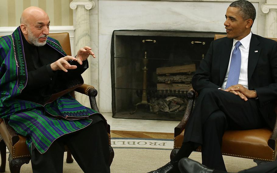 U.S. President Barack Obama meets with Afghan President Hamid Karzai in the Oval Office at the White House, January 11, 2013 in Washington, D.C.