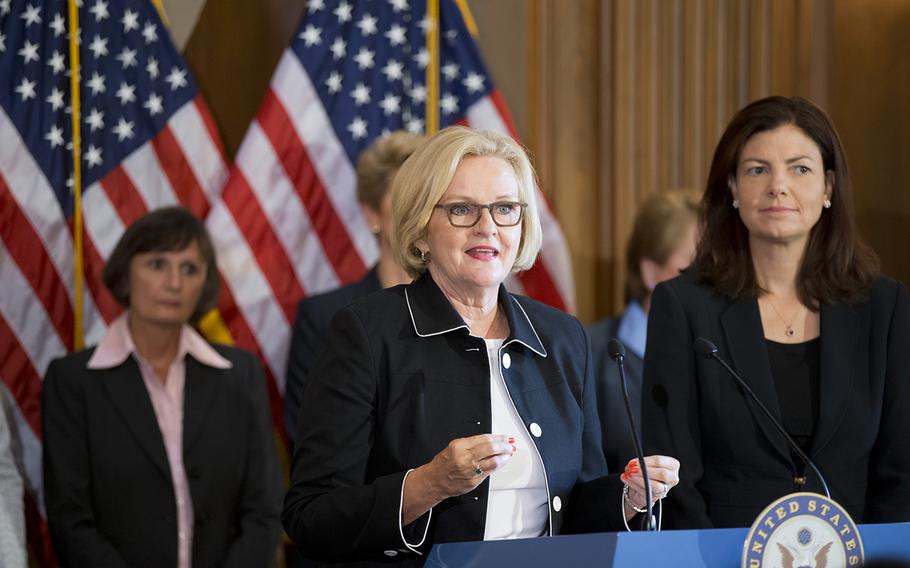 Sen. Claire McCaskill, D-Mo., center, and Sen. Kelly Ayotte, R-N.H., right, are joined by retired female members of the military's judge advocate corps at a news conference on Capitol Hill in Washington, Thursday, July 25, 2013, to discuss reforming the way sexual assault cases in the military are prosecuted.