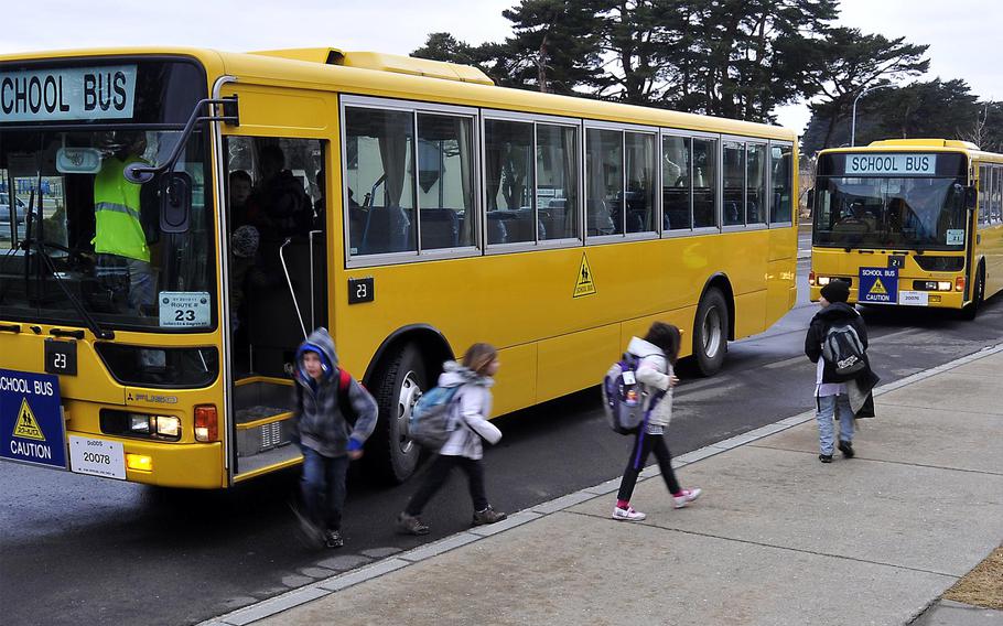 Students step off school buses at Sollars Elementary at Misawa Air Base, Japan, on March 21, 2011.