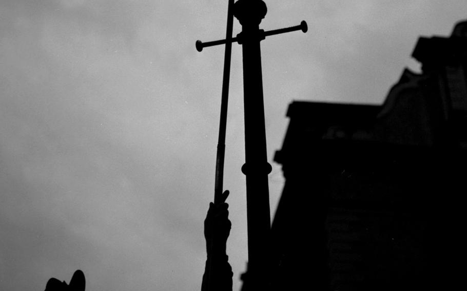 Munich city lantern ward Wilhelm Schuepfer lights a gas street light in July, 1961.