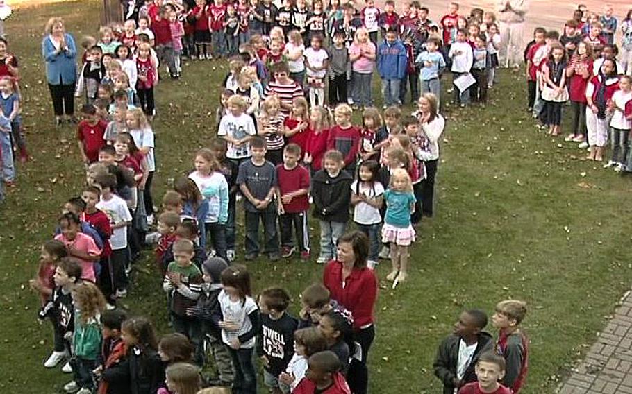 A video screen grab shows students at Feltwell Elementary School singing the National Anthem on Sept. 22, 2011.