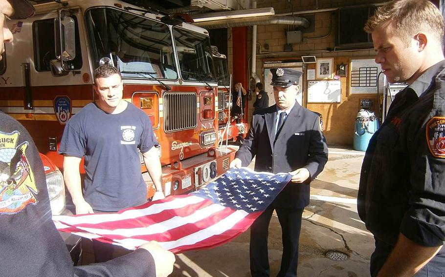 Members of the New York Fire Department, Engine Company 216, Ladder Company 108, who are also veterans, participate in a program where they have flags flown in combat or at Ground Zero in New York, and then present those flags to Gold Star families.