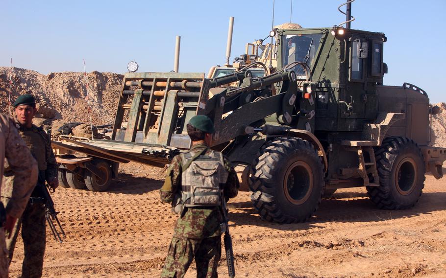 Afghan National Army soldiers provide security during the construction of Patrol Base Yeha in Helmand province, Afghanistan, on March 8, 2012.