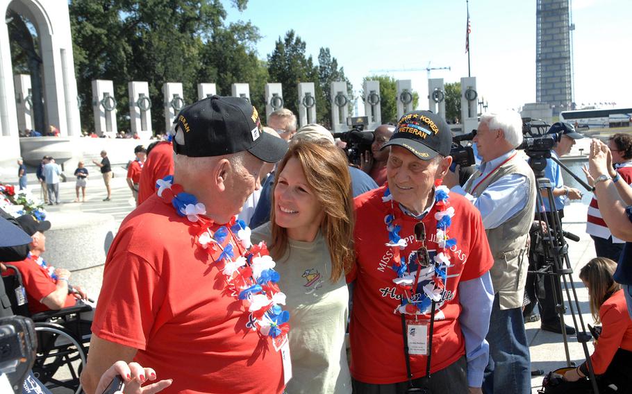 U.S. Rep. Michelle Bachmann, R-Minn., greets World War II veterans at the WWII Memorial in Washington, D.C. on Tuesday, Oct. 1, 2013. Bachmann said she was outraged to learn that a barricade had been placed around the memorial as a result of the federal shutdown. She said scissors were used to cut the security tape to let a group of Honor Flight veterans from Mississippi enter the site. 