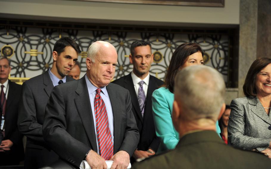 Sen. John McCain, R-Ariz., greets Marine Corps Commandant Gen. James Amos before a Senate Armed Services Committee hearing on sequestration at the Dirksen Senate Office Building in Washington, D.C., on Feb. 12, 2013.