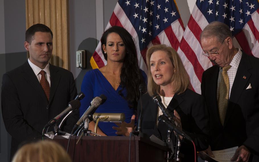 Sen. Kirsten Gillibrand (D-NY) calls for military sexual assault cases to be removed from the military chain of command on on Nov. 6, 2013 in Washington, D.C. Behind her are Ariana Klay, a former Marine officer who was sexually assaulted and her husband, Ben Klay (left), a former Marine, and Sen. Chuck Grassley (R-Iowa.)
