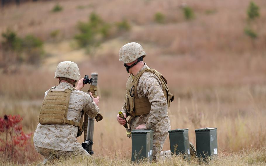 Cpl. Justin Auclair, assigned to the Warfighter Instructor Company, makes final adjustments to the Office of Naval Research's new Fire Control Unit 60mm Mortar sight during a demonstration Tuesday at Marine Corps Base Quantico, Va.