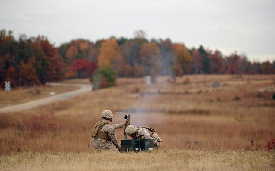 Marines use the Office of Naval Research's new Fire Control Unit 60 mm Mortar sight to accurately locate targets Tuesday during a demonstration at Marine Corps Base Quantico, Va. The FCU utilizes a mini red dot sight for day aiming and has laser capabilities for improved night fire accuracy when using the mortar in the handheld mode. ONR TechSolutions accepts recommendations and suggestions from Navy and Marine Corps personnel on ways to improve mission effectiveness through the application of new technology.