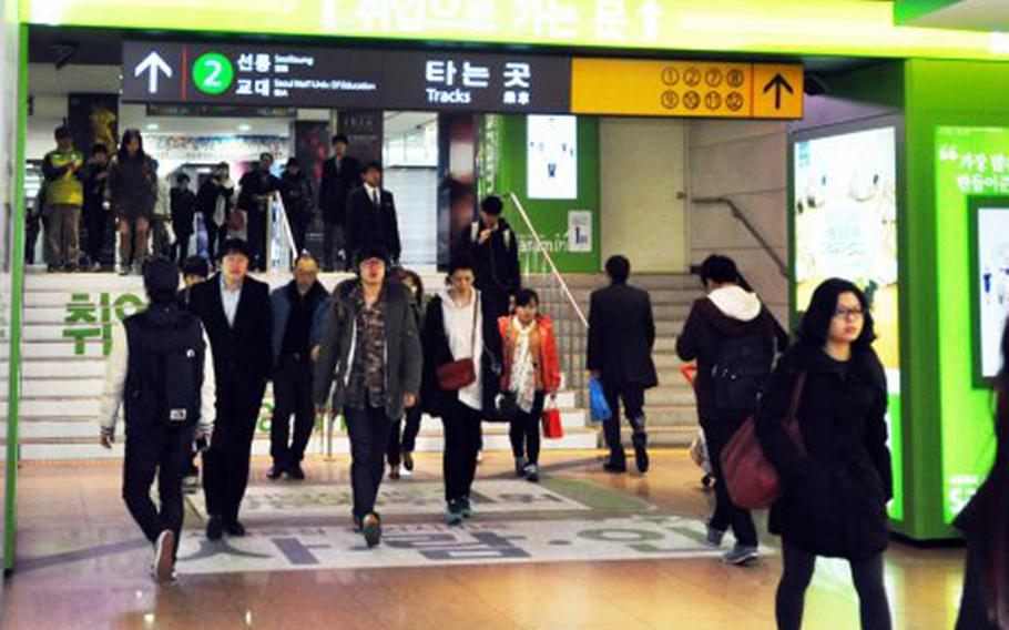 Commuters travel through a crowded Seoul, South Korea, subway station in February 2013.