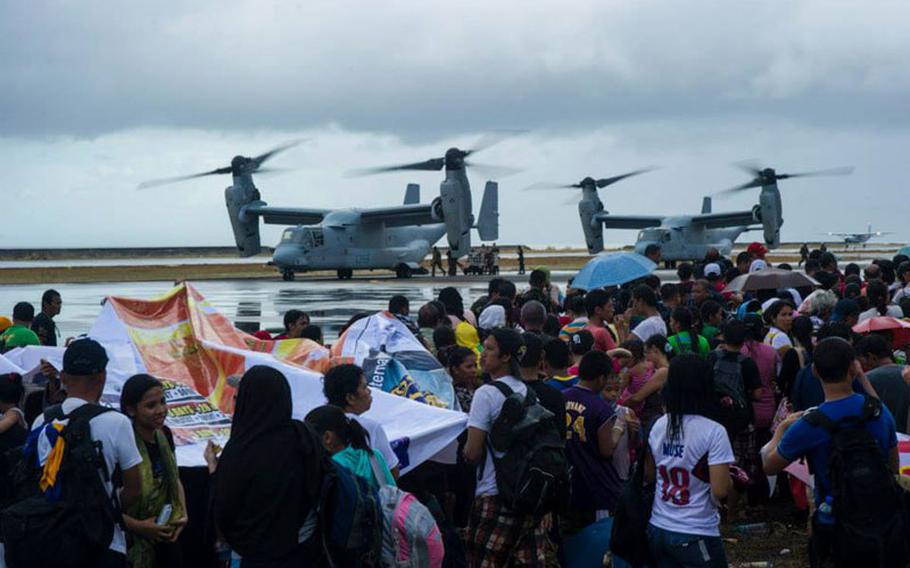 MV-22 Ospreys assigned to the Marine Medium Tiltrotor Squadron 261, 1st Marine Aircraft Wing, load supplies to provide aid during Operation Damayan.