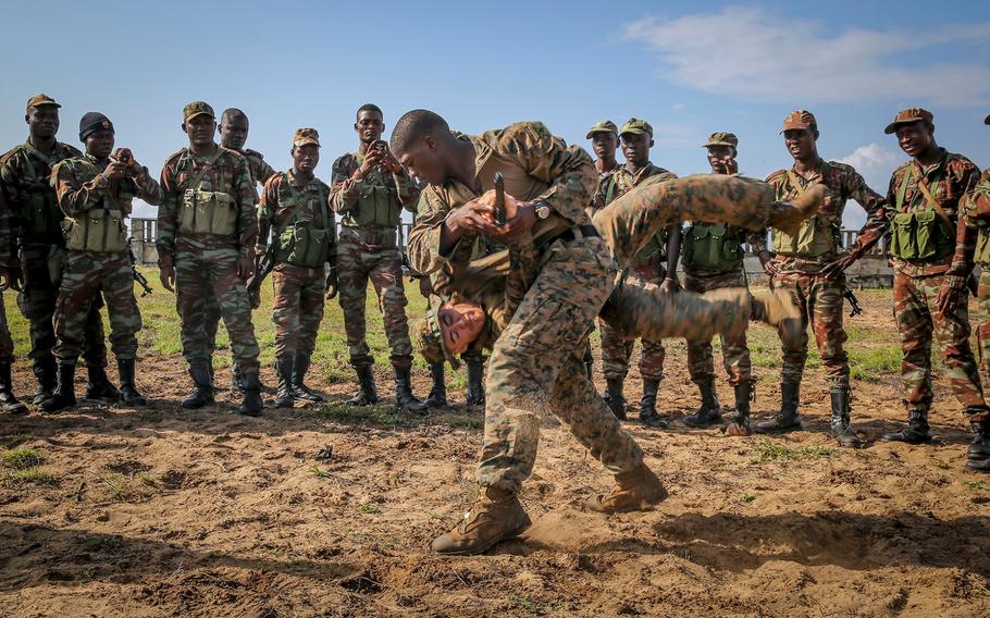 Marine Corps Martial Arts instructors demonstrate techniques during a martial arts class October 10, 2013, in Benin, Africa, where dozens of U.S. troops met with Benin Armed Forces to work on different tactical procedures in order to build on their maritime security capabilities.