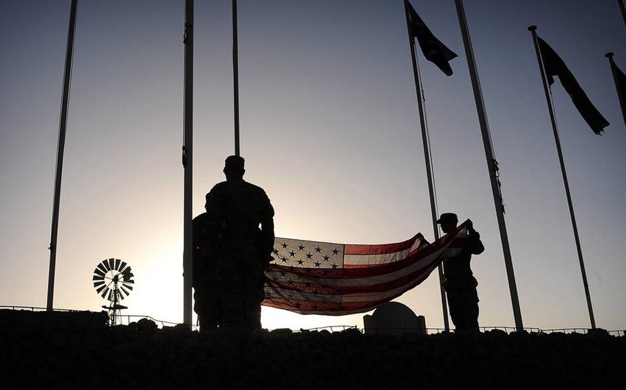 Soldiers with the California Army National Guard prepare to raise the American flag at Multinational Base Tarin Kowt in the Uruzgan province of Afghanistan, Aug. 5, 2013. 