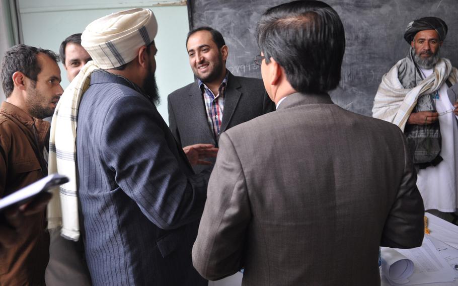 Members of the Afghan Loya Jirga discuss a security agreement that would pave the way for foreign troops to stay in Afghanistan past the end of 2014. The jirga, a gathering of 2,500 community leaders from around the country, was convened by President Hamid Karzai who has said he will respect the council's decision on the security agreement.
                