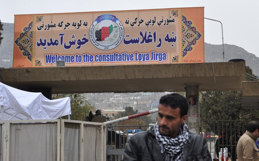 A sign outside the Afghan Loya Jirga, a gathering of 2,500 community leaders from around the country, who are debating a security agreement with the United States and that would pave the way for international troops to stay in Afghanistan past the end of 2014. The jirga was convened by President Hamid Karzai who has said he will respect the council's decision on the security agreement.