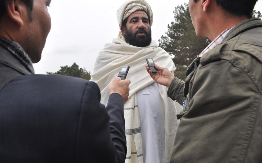 A member of the Afghan Loya Jirga is interviewed Saturday during the council's deliberation on a security agreement that would pave the way for foreign troops to stay in Afghanistan past the end of 2014. The jirga, a gathering of 2,500 community leaders from around the country, was convened by President Hamid Karzai who has said he will respect the council's decision on the security agreement.