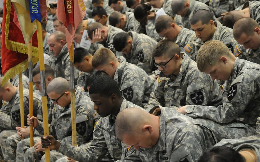 Soldiers of the 2nd Infantry Division mourn the loss of their fallen comrades Spc. Justin Adams and Maj. Evans Hanson during a Nov. 26, 2013, memorial ceremony at Camp Casey, South Korea.