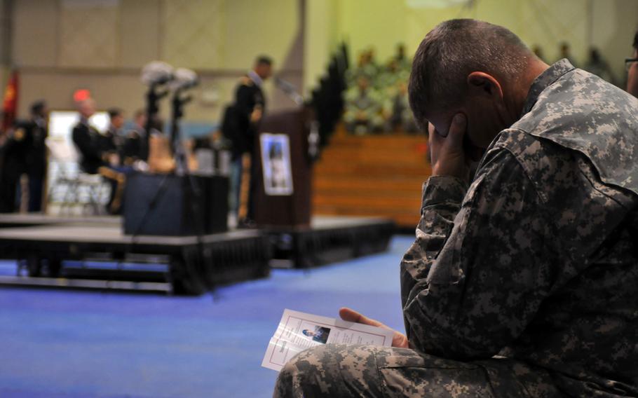 A 2nd Infantry Division soldier mourns the loss of his fallen comrades during a Nov. 26, 2013, memorial ceremony at Camp Casey, South Korea. 