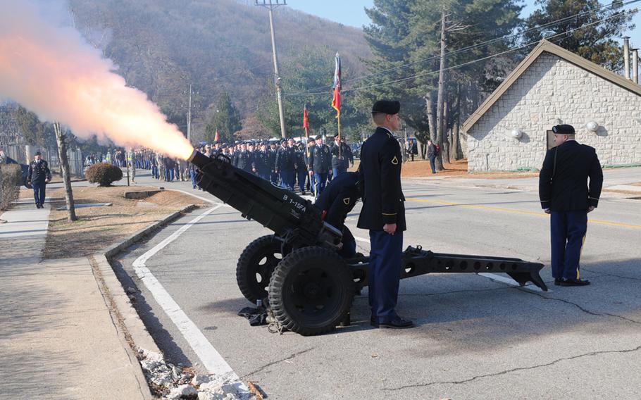 Soldiers of 1st Battalion, 15th Field Artillery Regiment, 1st Armored Brigade Combat Team, 2nd Infantry Division, march in honor of fallen soldiers Spc. Justin Adams and Maj. Evans Hanson during a Nov. 26, 2013, memorial ceremony at Camp Casey, South Korea. 