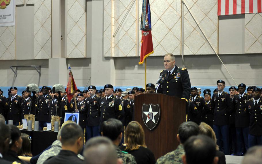 Lt. Col. Jeremy McGuire, 1st Battalion, 15th Field Artillery Regiment commander, speaks in honor of fallen soldiers Spc. Justin Adams and Maj. Evans Hanson during a Nov. 26, 2013, memorial ceremony at Camp Casey, South Korea. 