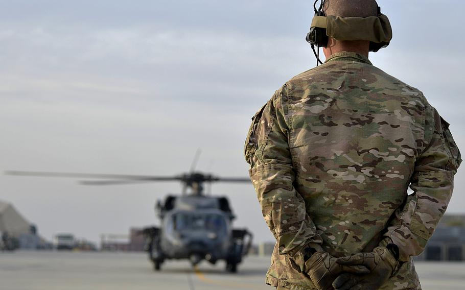 A U.S. Air Force Airman prepares to marshall a HH-60G Pave Hawk at Bagram Air Field, Afghanistan, Nov. 22, 2013. The Air Force is eliminating selective reenlistment bonuses for 46 career fields and cutting retraining opportunities for hundreds of airmen in over-manned specialties as the service prepares to trim the force by as many as 25,000 airmen over the next several years.