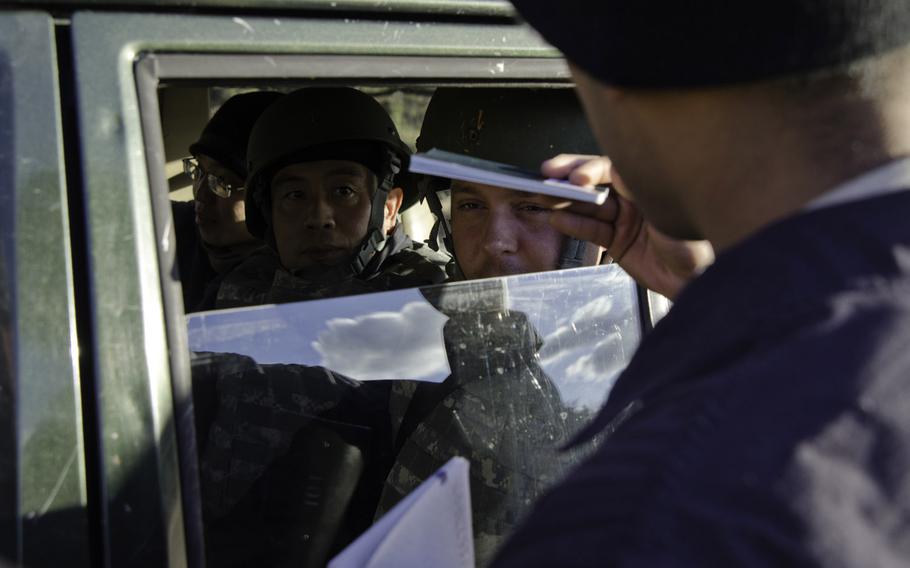 An inspector with the Organization for the Prohibition of Chemical Weapons (OPCW) attempts to go through a simulated checkpoint during Safe Secure Approaches to Field Environments training at the Joint Multinational Readiness Center in Hohenfels, Germany, Nov. 26, 2013.
