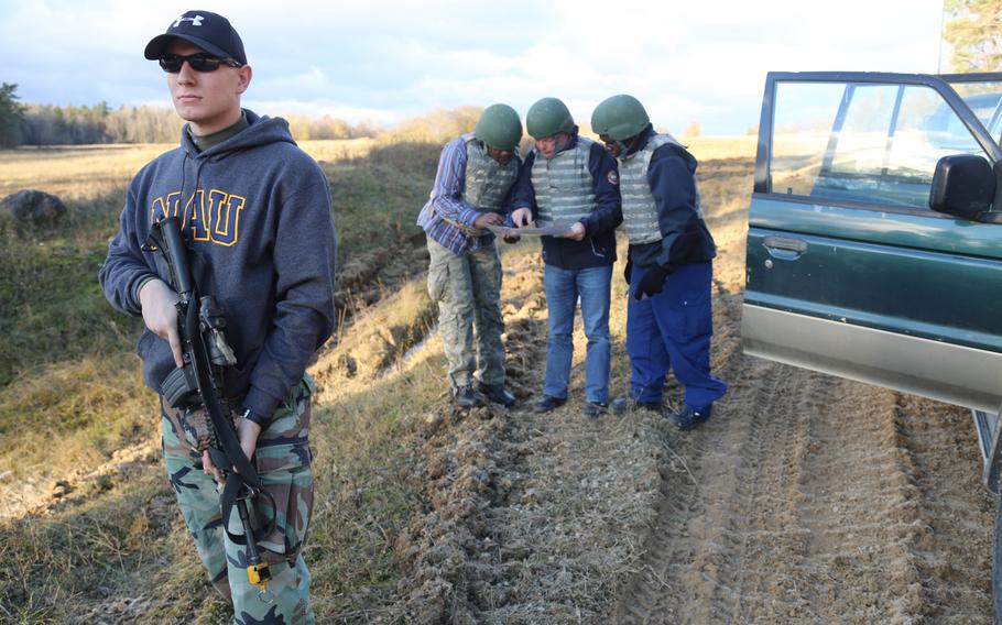 A U.S. Army Soldier with 1st Battalion, 4th Infantry Regiment, acting as a role-player, provides security for members of the Organization for the Prohibition of Chemical Weapons (OPCW) during Safe Secure Approaches to Field Environments training at the Joint Multinational Readiness Center in Hohenfels, Germany, Nov. 26, 2013.
                
