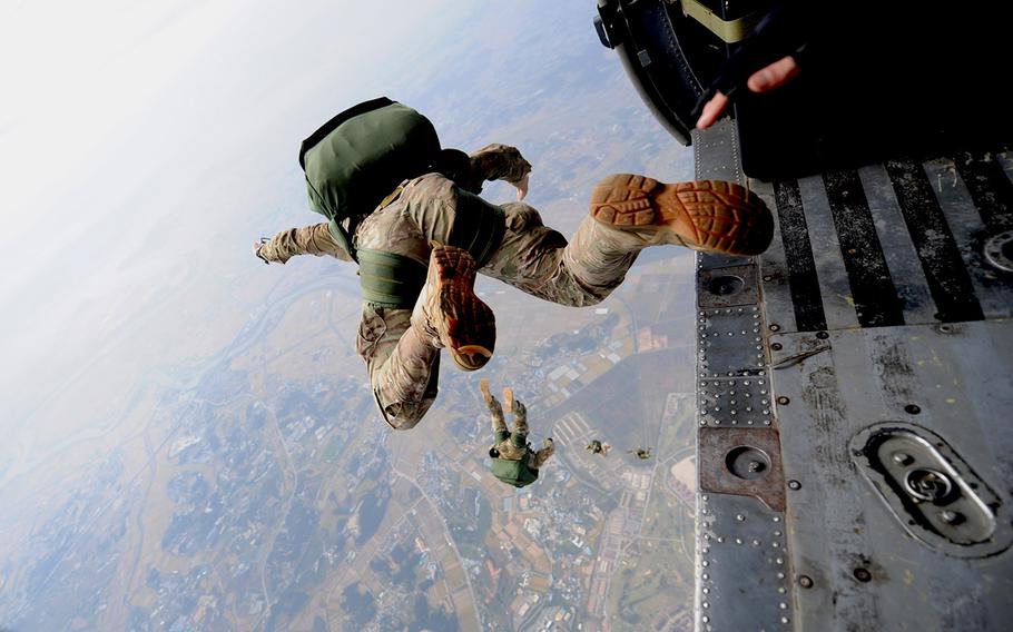 A pararescueman from the 31st Rescue Squadron freefalls with a parachute after jumping from a 33rd Rescue Squadron HH-60 Pave Hawk during training scenarios for PAIFIC THUNDER 2012 at Osan Air Base, South Korea, on Oct. 12, 2012.