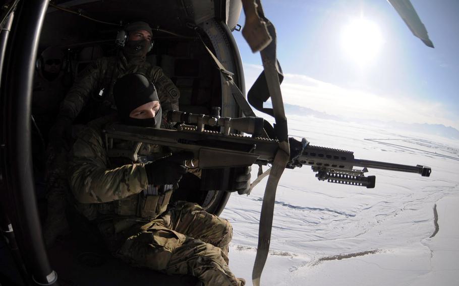 Cpl. William Hopkins looks through the scope of the Barrett .50 Cal. while Sgt. Lucas Cordes, a sniper team leader with Co. F, 282 CAB, waits for the Uh-60 Blackhawk to turn around so they can commence an aerial firing platform exercise Jan. 26.