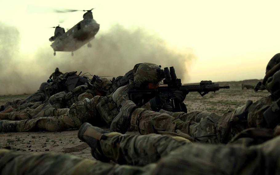 In this file photo from November 2013, Rangers from 1st Battalion, 75th Ranger Regiment, as part of a combined Afghan and coalition security force operating in Ghazni province, Afghanistan, await a CH-47 for extraction.