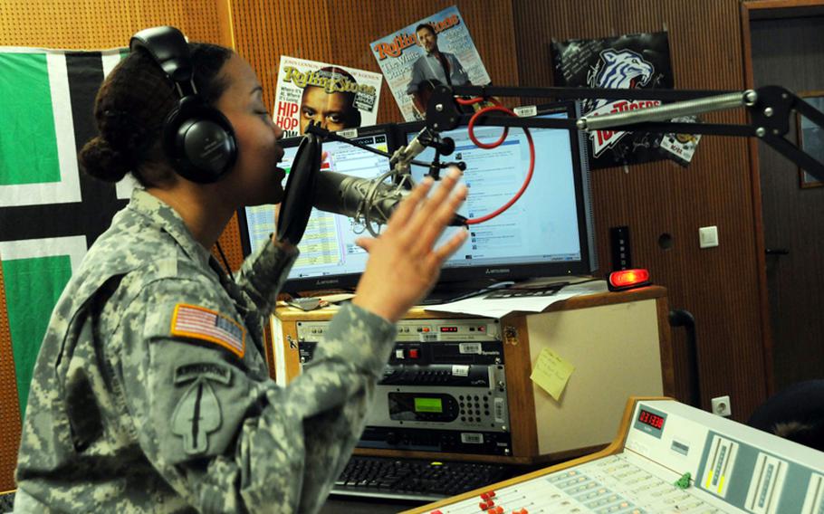 Spc. Monique Moore of AFN Bavaria gestures while speaking on air during her afternoon radio show, Feb. 14, 2013. Moore was recently named Soldier of the Year for AFN Europe.