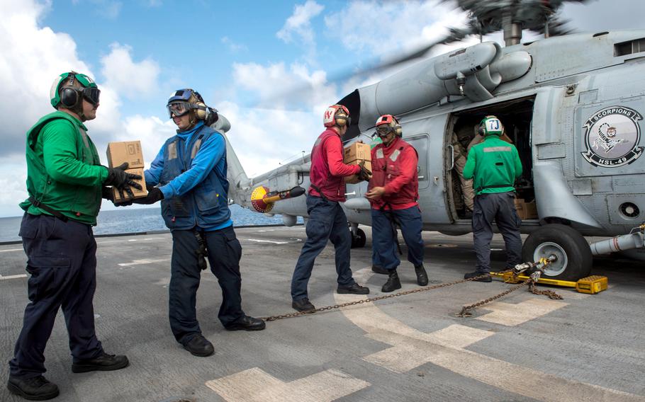 U.S. Sailors assigned to the littoral combat ship USS Freedom pack the cabin of an MH-60R Seahawk helicopter assigned to Helicopter Maritime Strike Squadron 73 with relief supplies from Project Handclasp Nov. 24, 2013, in Leyte Gulf, Philippines, during Operation Damayan.