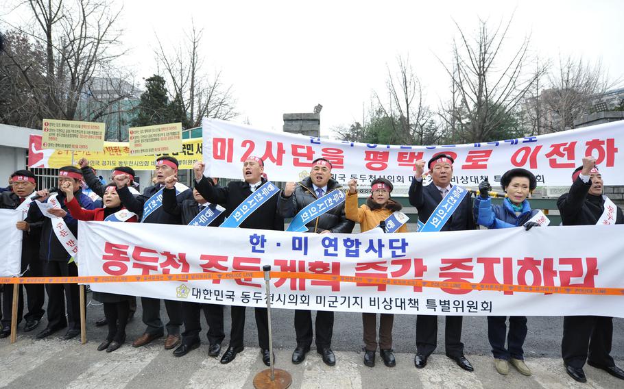 Dongducheon residents and members of the Dongucheon City Council protest the possible long-term presence of U.S. soldiers in their city Monday, Dec. 2, 2013, in front of the Ministry of National Defense headquarters in Seoul.