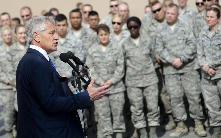 U.S. Defense Secretary Chuck Hagel, left, addresses troops on Al Udeid Air Base, Qatar, Dec. 10, 2013. Hagel thanked the troops for their service, took several questions and posed for personal pictures with the service members.