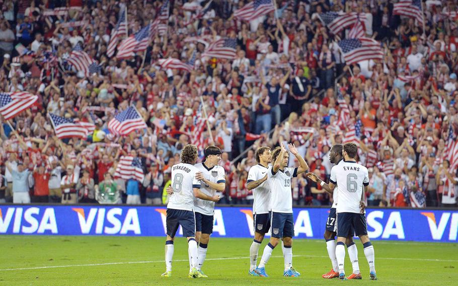 USA players congratulate each other after scoring a second goal against Jamaica in the second half of a World Cup qualifying match at Sporting Park in Kansas City, Kansas, Oct. 11, 2013. The USA defeated Jamaica, 2-0.