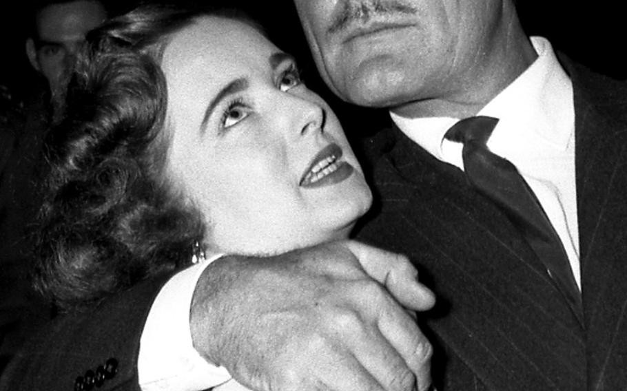 A lucky fan meets Errol Flynn at a March of Dimes benefit in Frankfurt in February, 1954.