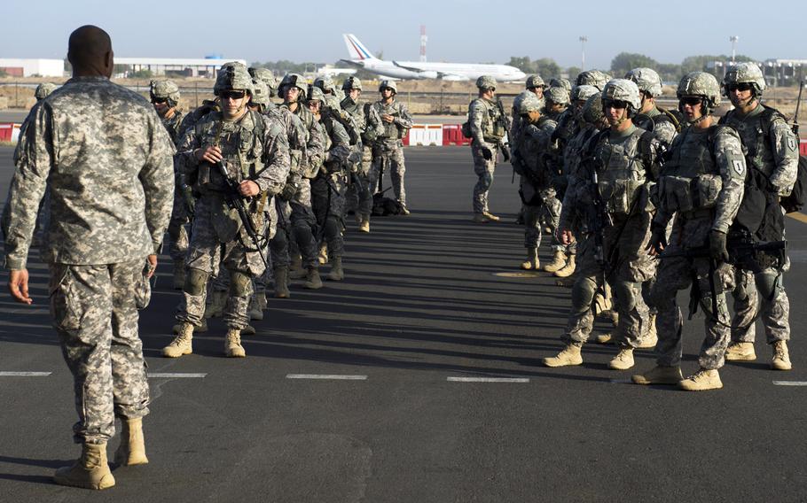 Soldiers of the East Africa Response Force prepare to load onto a U.S. Air Force C-130 Hercules at Camp Lemonnier, Djibouti, for departure to Juba, South Sudan, Dec. 18, 2013.