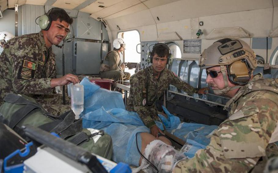 Medics with the Afghan air force work with the NATO Air Training Command-Afghanistan advisers to transport an injured soldier from a mission near Ghorak, Afghanistan, Sept. 23, 2013.