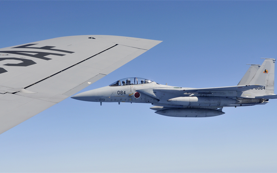 A Japan Air Self-Defense Force F-15 jet waits to refuel from a U.S. Air Force KC-135 Stratotanker during a mission at Kadena Air Base, Japan, May 17, 2010.