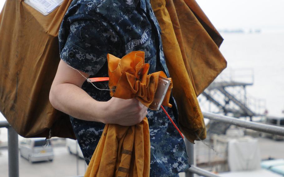 Sailors bring the latest mail aboard the USS Denver at White Beach Naval Facility, Okinawa, Feb. 4, 2014. Sailors from the Denver and members of the 3rd Marine Division are heading to Thailand in support of the upcoming Exercise Cobra Gold 2014.
                