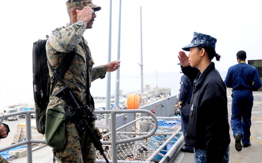 Sailors and Marines board the USS Denver at White Beach Naval Facility, Okinawa, Feb. 4, 2014. Sailors from the Denver and members of the 3rd Marine Division are heading to Thailand in support of the upcoming Exercise Cobra Gold 2014.
                
