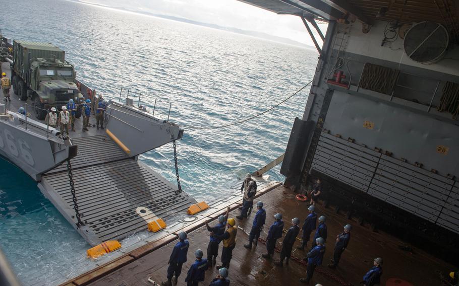 Marines and sailors embark mission equipment aboard the USS Denver at White Beach Naval Facility, Okinawa, Feb. 3, 2014. Sailors from the Denver and members of the 3rd Marine Division are heading to Thailand in support of the upcoming Exercise Cobra Gold 2014.
                